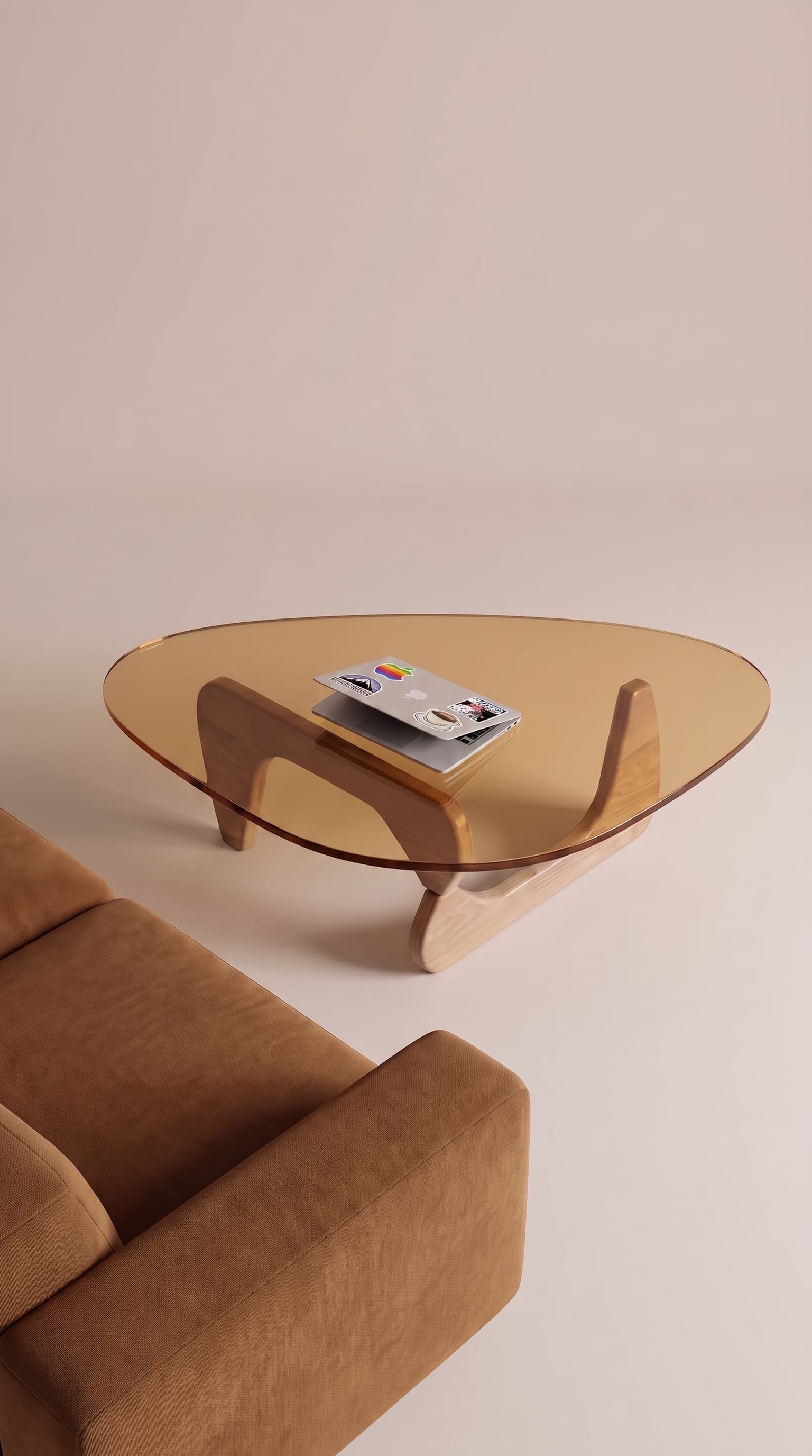 Same coffee table styled in a bright living room with a cognac sofa and laptop